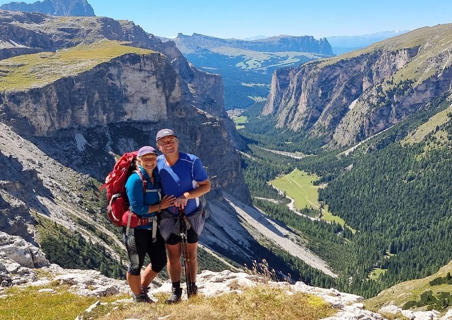 A person and person standing on a mountainDescription automatically generated